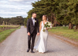 A bride and groom holding hands at Dromana Estate